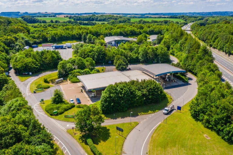 Aerial view Winchester Services with parking and facilities surrounded by green fields.